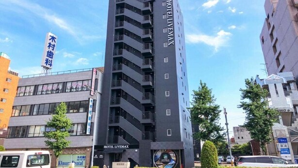 A modern hotel building with multiple floors, balconies, and a prominent 'HOTEL LIVEDMAX' sign. - Hotel Livemax Budget Nagoya Taiko Doriguchi (Nagoya)