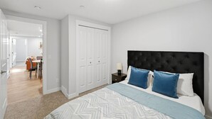 A bedroom with a bed, nightstand, and wardrobe. - Luxury 2bedroom Suite With Park Views in Calgary (Calgary)