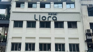 A hotel with a sign for 'Hotel Liora' and 'TBZ Tribhuvanas Bhimji Zaveri' below. - Hotel Liora (Rajkot)