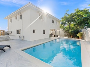A white building with a swimming pool, outdoor furniture, and a staircase leading to the entrance. - Villa Esperanza Ocean View Villa |Private Pool | Gated Community | Walk to Beach (Dawn Beach)
