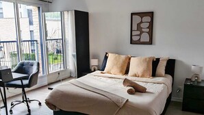 A bedroom with a bed, a desk, a chair, a window, and a wall-mounted artwork. - House near Versailles & Paris with parking (Louveciennes)