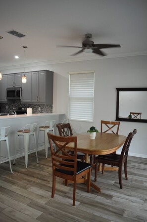 A modern kitchen with grey cabinets, a microwave, and a built-in oven. - Superb 2-bedroom house with AC in sunny Sarasota (Sarasota)
