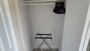 A small, enclosed closet with a metal drying rack and a shelf. - Baby Blue! (Port Charlotte)
