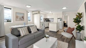Un salón moderno con sofá, mesa de centro y mesa de comedor.