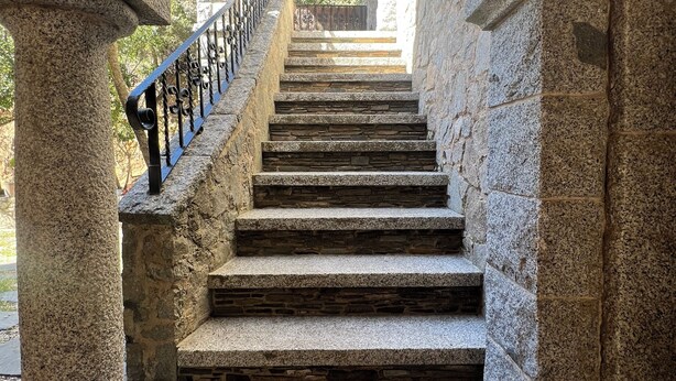 A stone staircase with a metal railing, leading to an arched doorway. - Forest retreat, close to Barcelona and Beaches (Dosrius)
