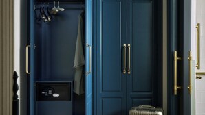 A room with a blue wardrobe, a suitcase, and a handbag on the floor.