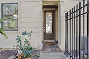 A house with a front door, number 1905, potted plants, a metal fence, and a window. - Pool, Hot Tub, 3 bedrooms 3 bathrooms walkable cute neighborhood near downtown. (Houston)