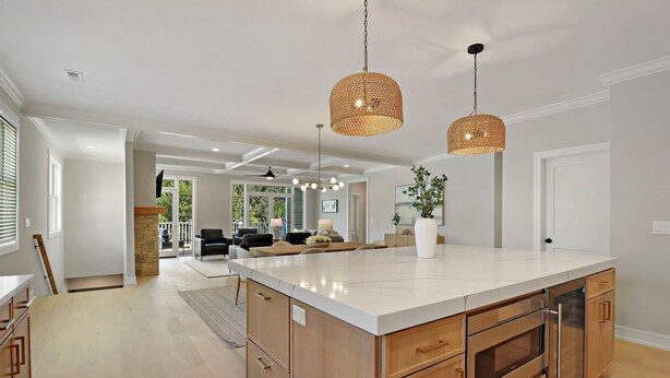 A spacious kitchen with a large island, wooden cabinets, and a modern pendant light. - NEW LUXURY Condo - Walk to The Abbey! Sleeps 10! Fontana-on-Geneva Lake (Fontana-on-Geneva Lake)