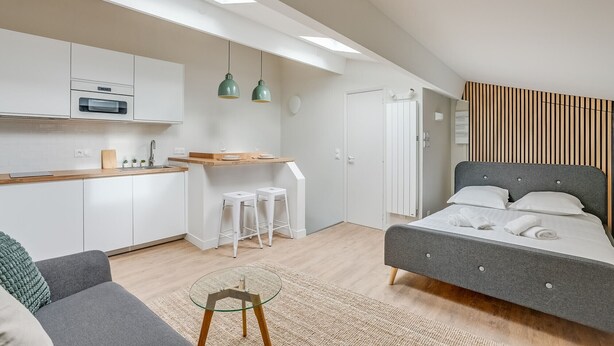 A modern, compact room with a kitchenette, a bed, and a seating area. - Bright Studio at Nation, Paris 12th (Paris)