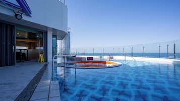 Outdoor pool, open 2:00 PM to 10:00 PM, pool loungers
