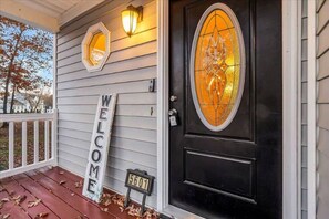 A house with a black door, a welcome sign, a mailbox, and a light fixture. - MidTerm Housing  Utilities Included Move-In Ready (Prince George)