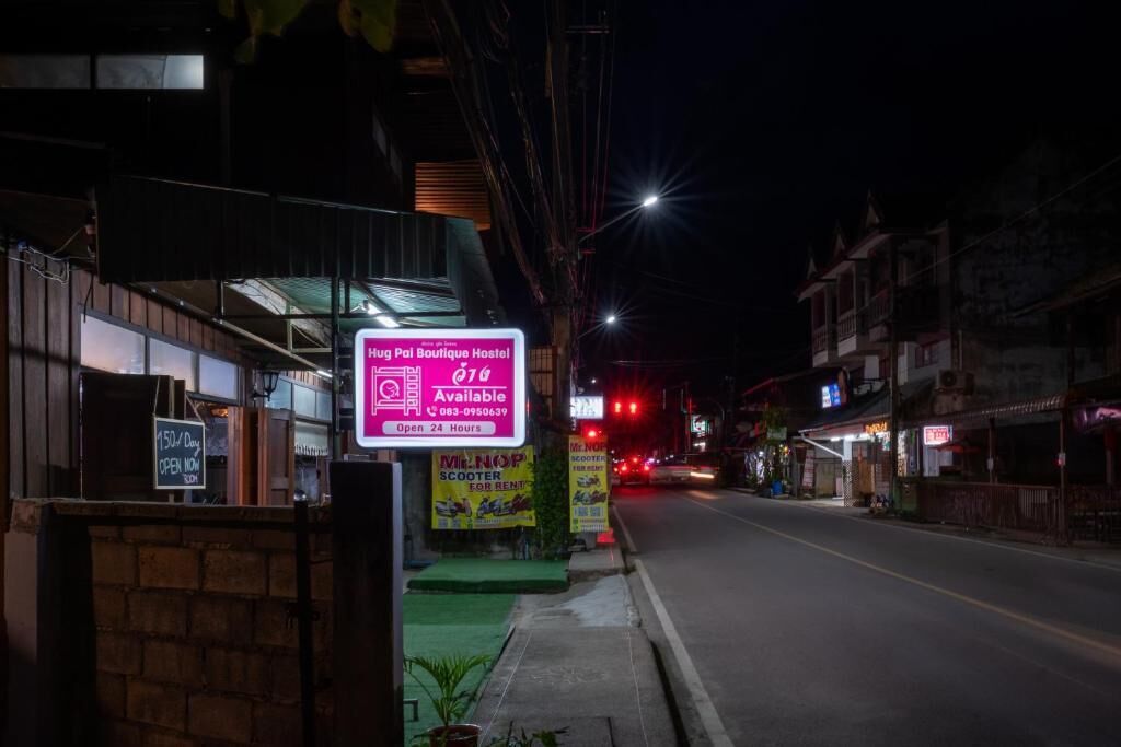 A hostel with a sign indicating availability and a 24-hour open policy.