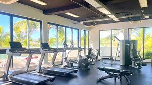A gym with treadmills, elliptical machines, and weight benches. - Azuri Resort Villa: Pool, Golf & Beach Club (Rivière du Rempart)