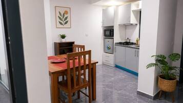 Deluxe Apartment, Patio | Living area | 32-inch Smart TV with satellite channels