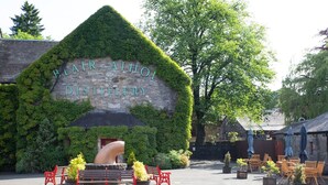A building with a stone facade and a sign that reads 'Blair Athol Distillery.' - Design-led Apartment | Central Pitlochry (Pitlochry)