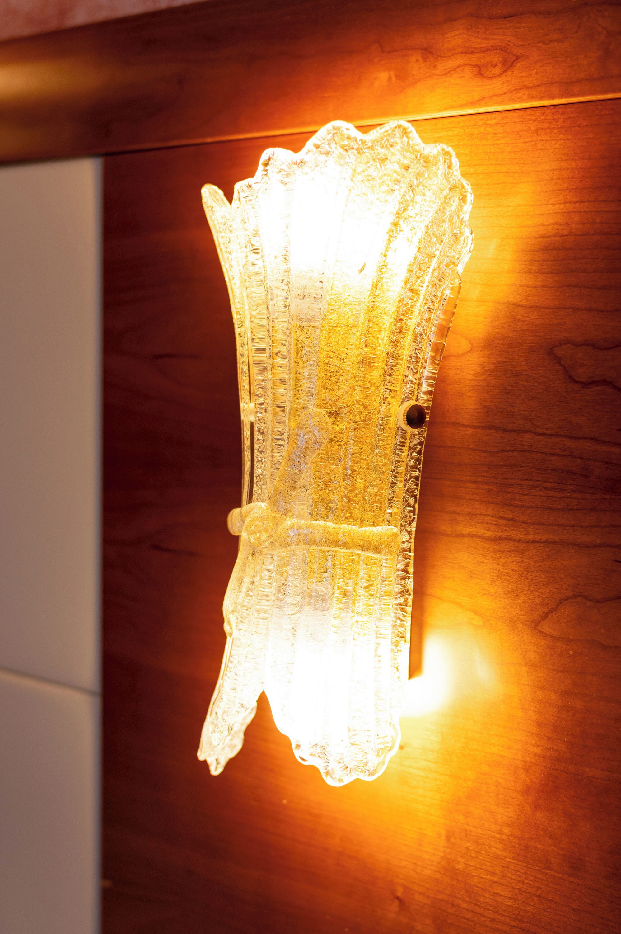 A wall-mounted light fixture with a textured, translucent design.