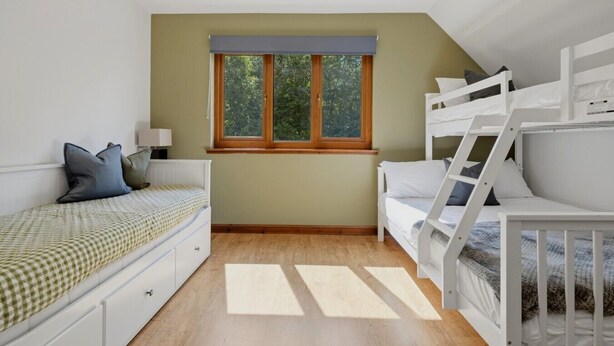 A bedroom with a bunk bed, a single bed, a window with curtains, and a bedside table with a lamp. - Loch View, Hot Tub, Near Loch Lomond, Pet-friendly (Arrochar)