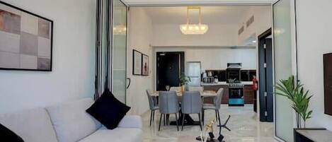 Luxury Apartment, Balcony, City View | Living area | 65-inch Smart TV with cable channels