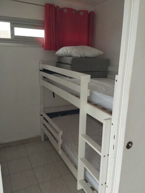 A bunk bed with a window, a red curtain, and a white door. - Incredible sea view (Leucate)