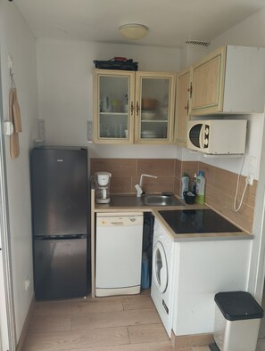 A compact kitchen with a refrigerator, dishwasher, microwave, and washing machine. - Incredible sea view (Leucate)
