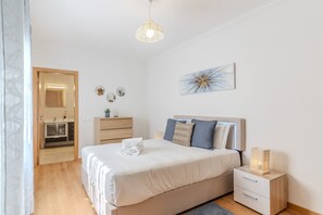 A bedroom with a bed, bedside table, and a small cabinet. - #368 T2 Apartment | Sea View & Terrace Albufeira (Albufeira)