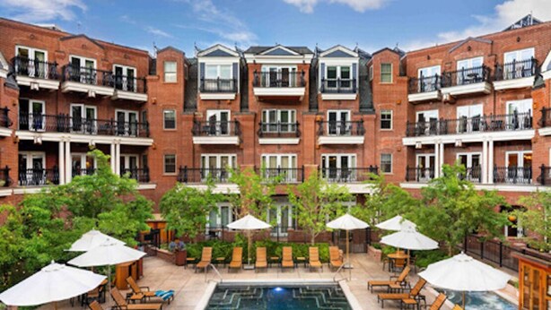 A multi-story building with a swimming pool, outdoor seating, and greenery. - Perfect condo in enchanting Aspen for your next getaway (Aspen)