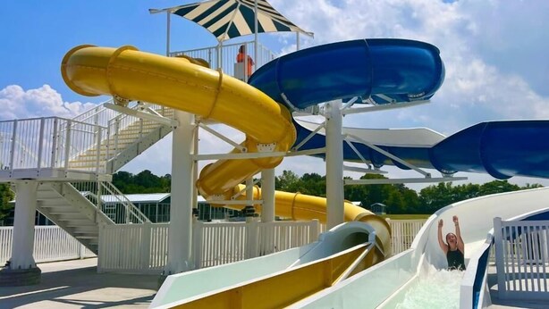A water park with multiple slides and a covered area. - Jellystone Park Delaware Beaches (Lincoln)