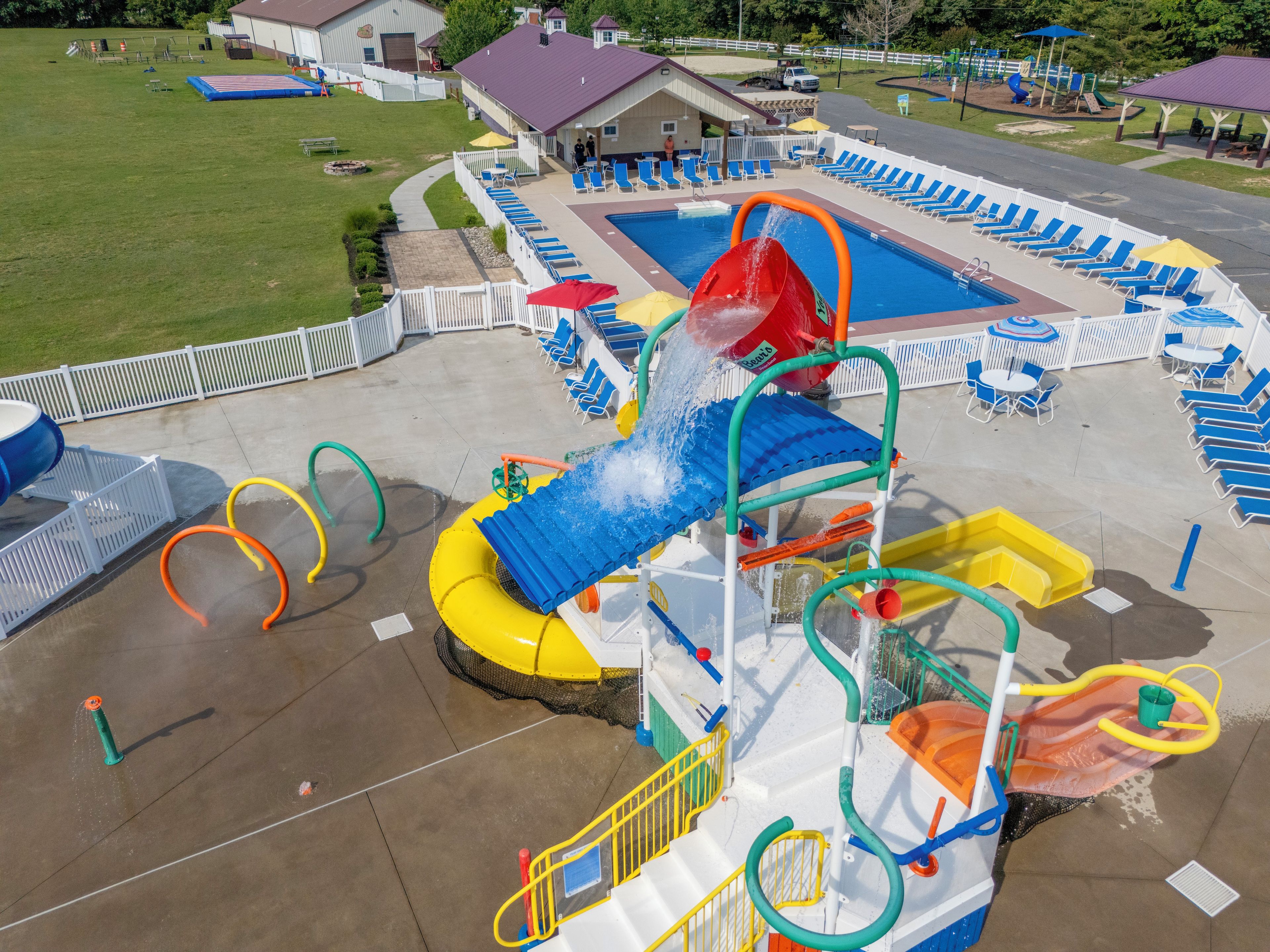 A water park with a pool, slides, and a play area.