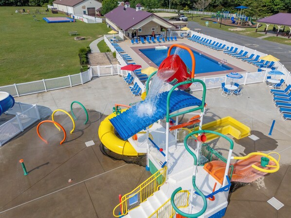 A water park with a pool, slides, and a play area.