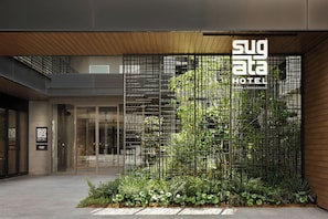 A modern hotel entrance with a vertical garden and a sign for Sugata Hotel. - Sugata Hotel Osaka Shinsaibashi, Series By Marriott (Osaka)