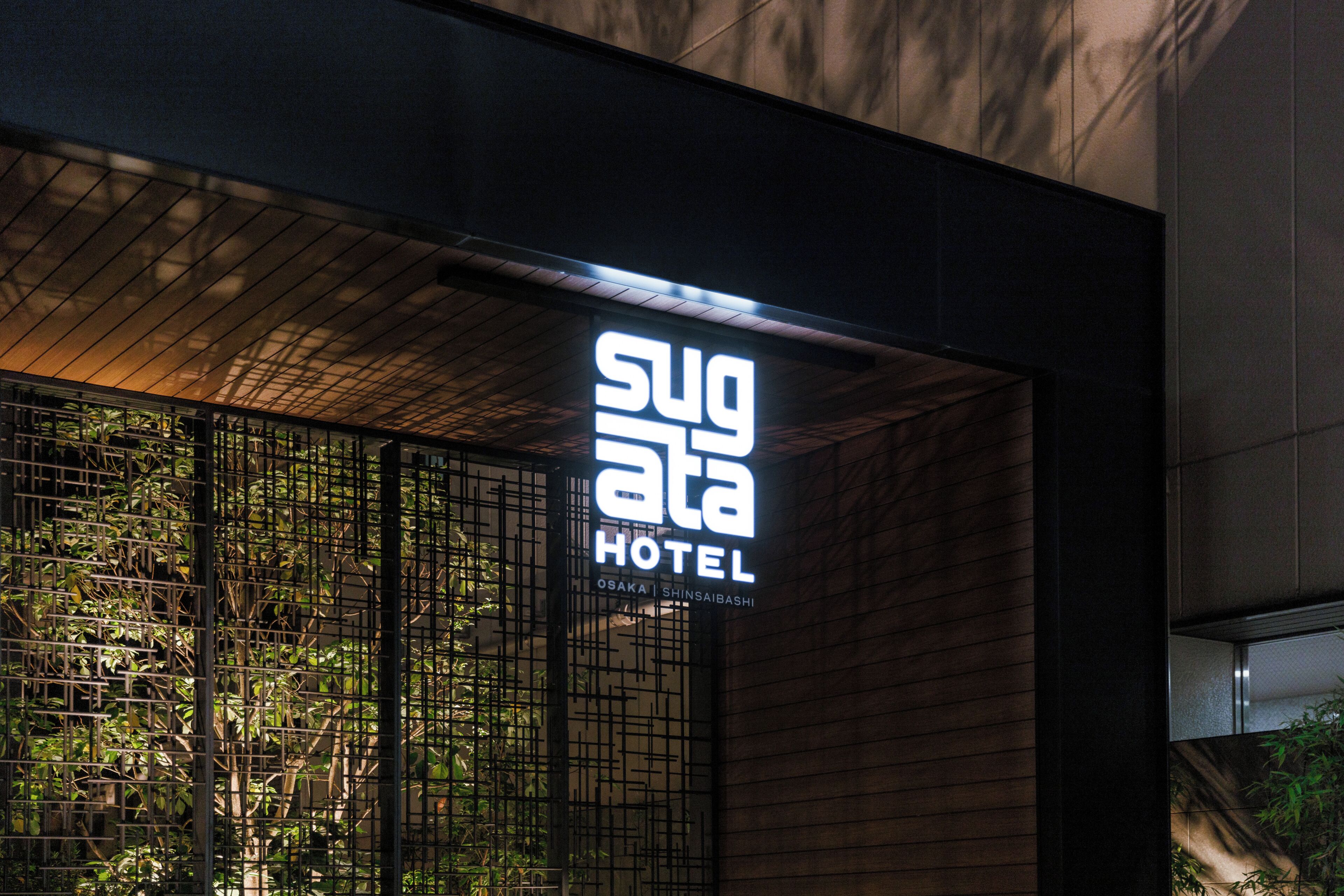Een hotelschiltje met de naam 'Sugata Hotel' en de locatie 'Osaka | Shinsaibashi'.