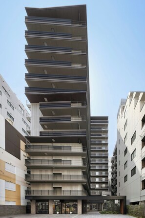 A multi-story building with a modern architectural design, featuring balconies and a ground-level entrance. - Sugata Hotel Osaka Shinsaibashi, Series By Marriott (Osaka)