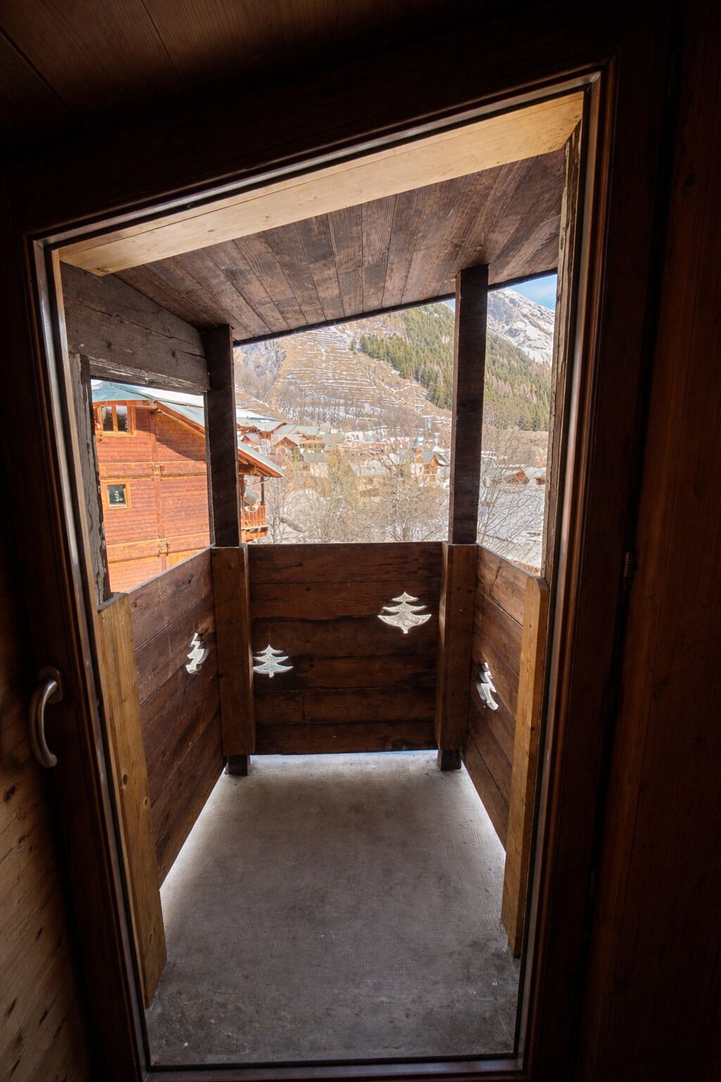 Une cabane en bois offrant une vue sur un paysage montagneux.