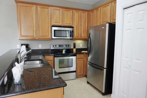 Fridge, microwave, oven, stovetop - Sunshine Stay Near Disney  2BR  Walk to Pool (Kissimmee)