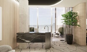 A modern bathroom with a marble sink, a potted plant, and a view of a cityscape through large windows.