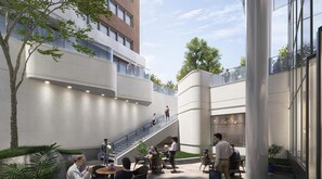 A modern building with a glass staircase, outdoor seating, and a mix of indoor and outdoor spaces. - Signia Hilton Indianapolis (Indianapolis)
