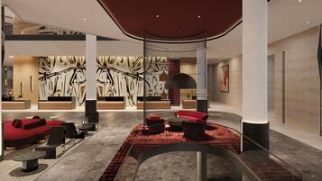 A modern lobby with a red carpet, seating areas, and abstract wall art.