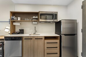 A compact kitchen with a microwave, refrigerator, coffee maker, and a dishwasher. - Home2 Suites By Hilton Powell Knoxville North (Knoxville)