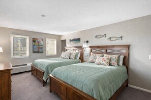 A bedroom with two beds, a dresser, and a window. - Boyne Peak + Pool Retreat -Golfing, Waterpark, Skybridge & Events (Boyne Falls)