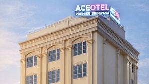 A multi-story hotel with a classic architectural style, featuring a prominent sign at the top.