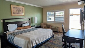 A hotel room with a bed, a desk, a chair, a window with blinds, and a picture on the wall. - Cloud 9 Motel Cypress Buena Park (Cypress)