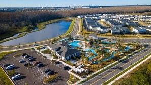 An aerial view of a residential area with a swimming pool, parking lot, and houses. - Last Minute Disney Getaway! Private Pool & Themed Bedrooms. Book Now! #165355 (Orlando)