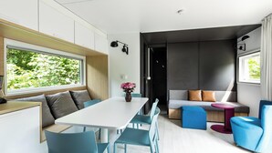 Um interior moderno com uma área de jantar, um sofá e uma pequena mesa.