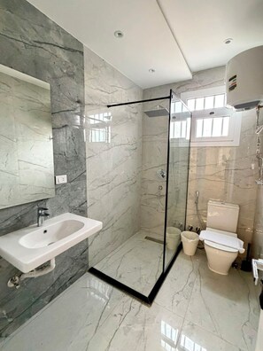 A bathroom with a glass-enclosed shower, a sink, and a toilet. - VESTA  - Luxury APT - 3BR - South Teseen (III) (New Cairo City)
