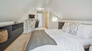 A bedroom with a bed, a desk, a chair, and a television. - Annapolis Gem- Tranquil 4 BR Murray Hill Victorian (Annapolis)
