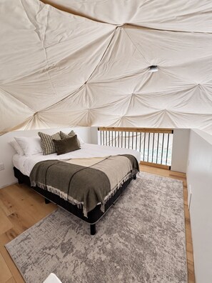 A bedroom with a bed, pillows, a blanket, a rug, and a tent-like structure above. - The Flats - Premium Dome at Granda Rose Retreat (Branch)