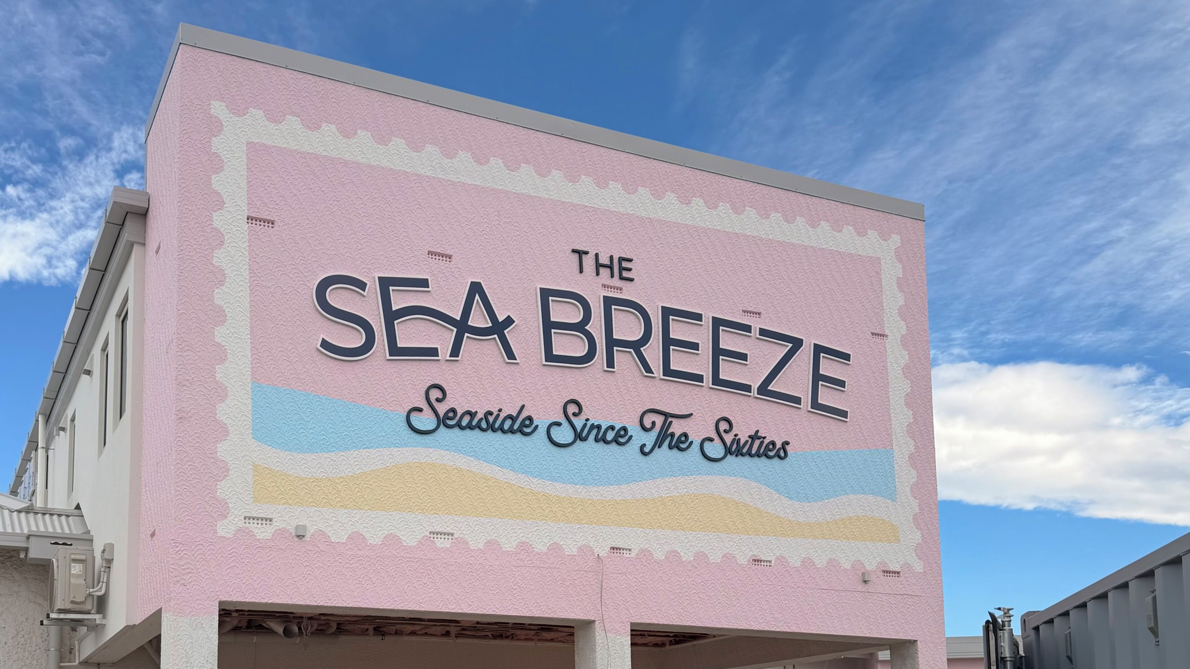 A building with a large sign reading 'The Sea Breeze' and 'Seaside Since The Sixties.'
