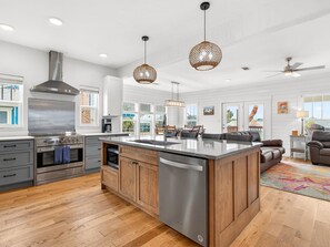 A modern kitchen with a central island, stainless steel appliances, and pendant lighting. - The Redfish Palm -  Rockport, Texas (Rockport)
