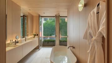 Separate bathtub and shower, hair dryer, slippers, towels
