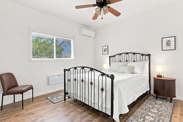 A queen bedroom with a classic metal bed frame.